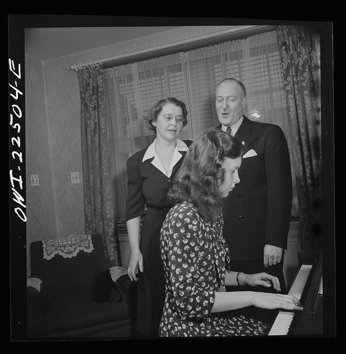 Philadelphia, Pennsylvania. Swedish-American executive at the SKF roller bearing factory sings Swedish songs with his wife and daughter
