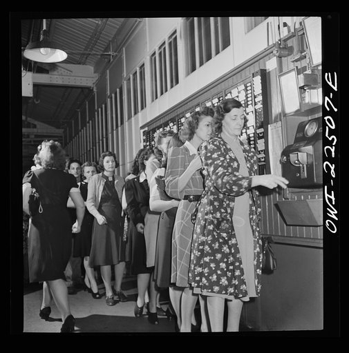 Philadelphia, Pennsylvania. Workers punching the clock at the SKF roller bearing factory