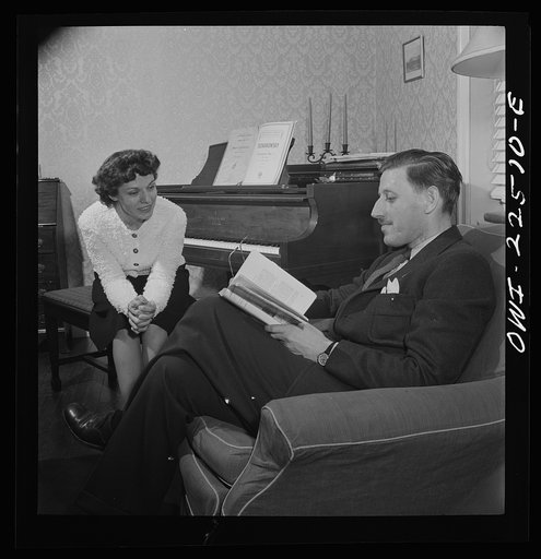 Untitled photo, possibly related to: Swedish-American foreman at the SKF roller bearing plant reads to his Italian-American wife at home. Philadelphia, Pennsylvania