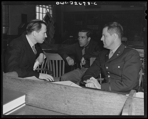 Charlottesville, Virginia. Officers enrolled in the School of Military Government at the University of Virginia conferring in the Library of International Law with a civilian specialist on Japanese relations