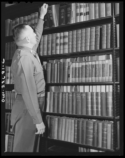 Untitled photo, possibly related to: Charlottesville, Virginia. A colonel who is attending the School of Military Government selecting materials for research in the Library of International Law at the University of Virginia