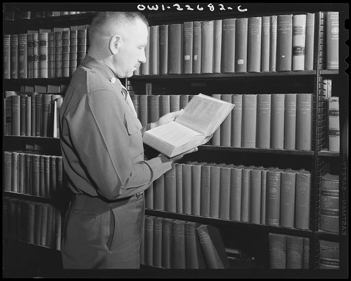Untitled photo, possibly related to: Charlottesville, Virginia. A colonel who is attending the School of Military Government selecting materials for research in the Library of International Law at the University of Virginia