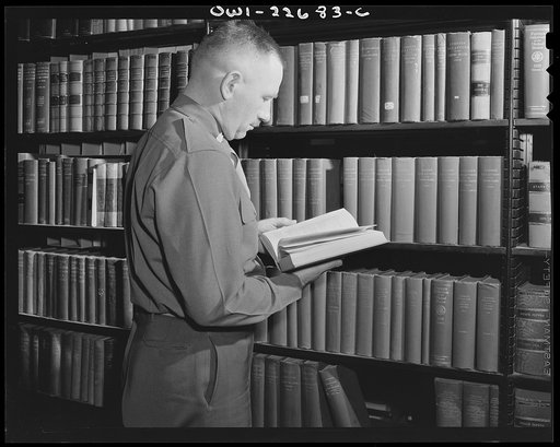 Charlottesville, Virginia. A colonel who is attending the School of Military Government selecting materials for research in the Library of International Law at the University of Virginia