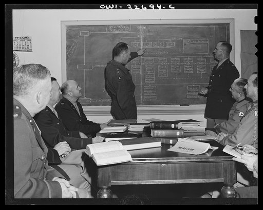 Untitled photo, possibly related to: Charlottesville, Virginia. Meeting of a committee of ten studying the administration of occupied areas in the School of Military Government at the University of Virginia. The officer at left of the blackboard is Lieutenant Colonel R.J. Weale, of the British Army