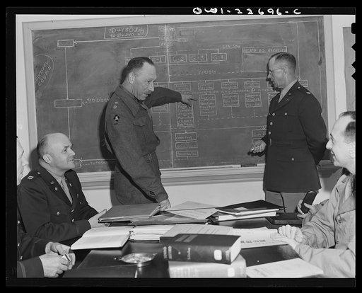 Charlottesville, Virginia. Meeting of a committee of ten studying the administration of occupied areas in the School of Military Government at the University of Virginia. The officer at left of the blackboard is Lieutenant Colonel R.J. Weale, of the British Army