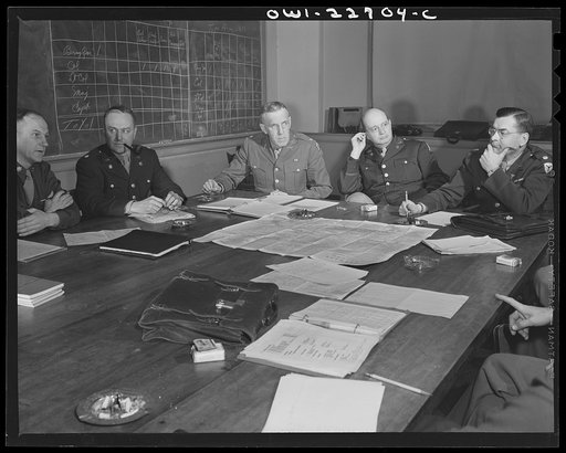 Untitled photo, possibly related to: Charlottesville, Virginia. Officers assigned to the problem of foreign administrative policy in a committee meeting in the School of Military Government at the University of Virginia