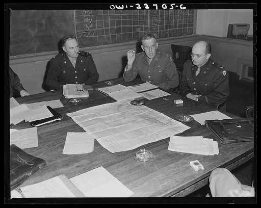 Untitled photo, possibly related to: Charlottesville, Virginia. Officers assigned to the problem of foreign administrative policy in a committee meeting in the School of Military Government at the University of Virginia