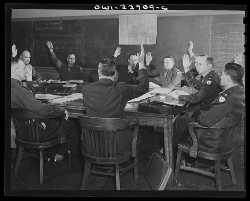 Charlottesville, Virginia. Committee of ten in the School of Military Government at the University of Virginia raising their hands in agreement on a point of politcal tactics to be used in administrative policy in a supposed occupied territory