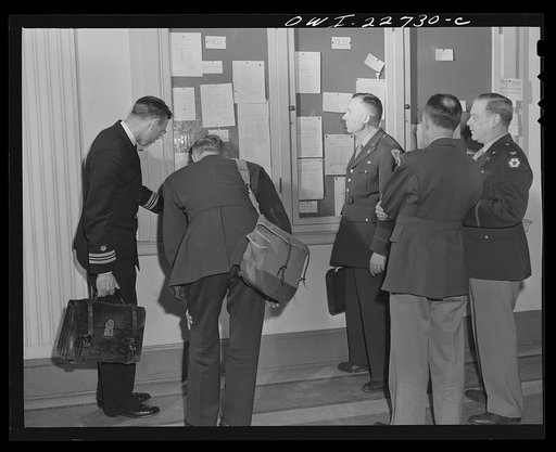 Charlottesville, Virginia. Officers enrolled in the School of Military Government checking their class assignments on the school's bulletin board at the University of Virginia
