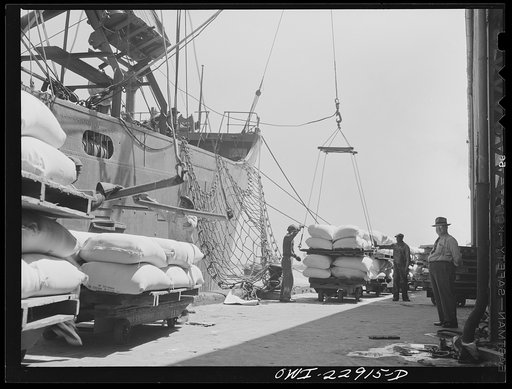 New Orleans, Louisiana. Loading sacks of flour onto a ship at the Poydras Street dock