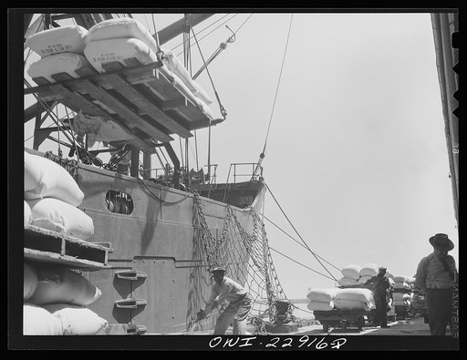 Untitled photo, possibly related to: New Orleans, Louisiana. Loading sacks of flour onto a ship at the Poydras Street dock