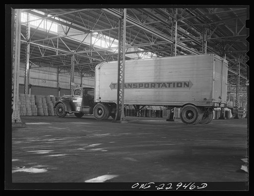 New Orleans, Louisiana. Trucks unloading goods in a warehouse at the Poydras Street dock