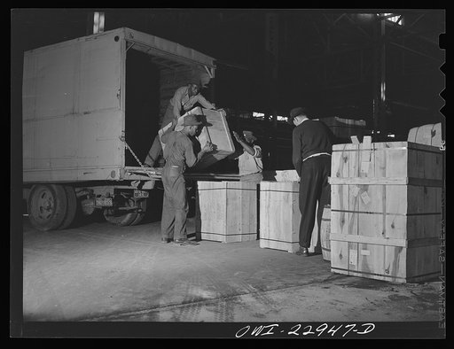 New Orleans, Louisiana. Trucks unloading goods in a warehouse at the Poydras Street dock