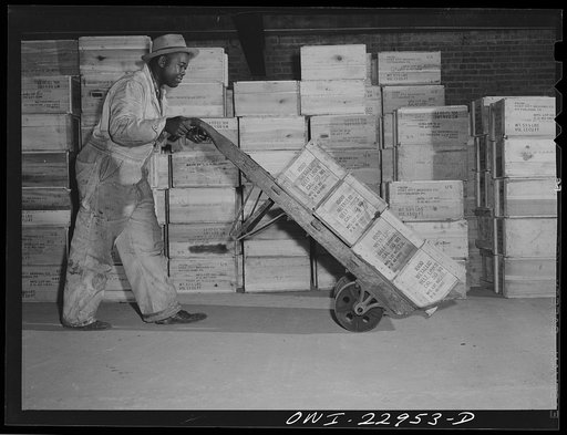 New Orleans, Louisiana. Loading ammunition onto a truck at the Associated Transport Company terminal