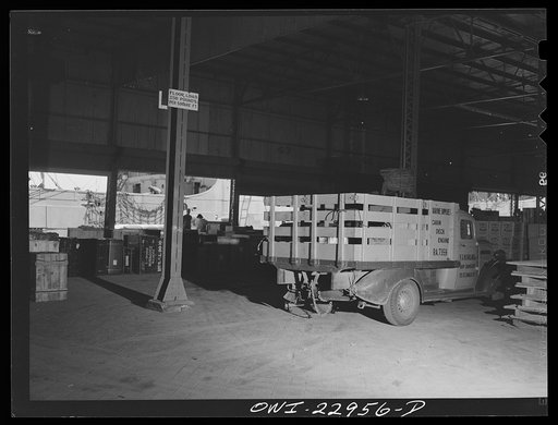 New Orleans, Louisiana. Trucks unloading goods in a warehouse at the Poydras Street dock