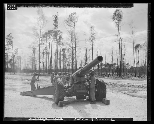 Camp Lejeune, New River, North Carolina. A 155 millimetre coast defense gun being studied by members of the 51st Composite Battalion, U.S. Marine Corps