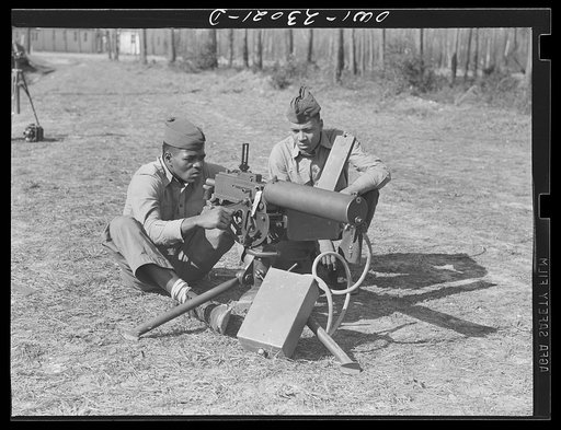 Camp Lejeune, New River, North Carolina. Engineers of the 51st Composite Battalion, U.S. Marine Corps, firing a 30 calibre machine gun on the range
