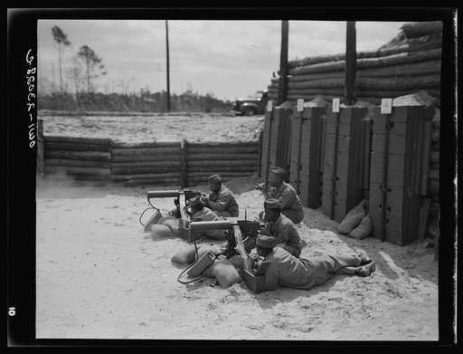 Camp Lejeune, New River, North Carolina. Engineers of the 51st Composite Battalion, U.S. Marine Corps, firing a thirty calibre machine gun on the range