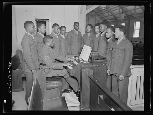 Camp Lejeune, New River, North Carolina. Private First Class Walker Manly, organist, rehearsing with members of the 51st Composite Battalion for a camp chapel service