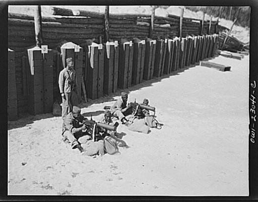 Camp Lejeune, New River, North Carolina. Engineers of the Fifty-first Composite Battalion, United States Marine Corps, firing a thirty calibre machine gun on the range