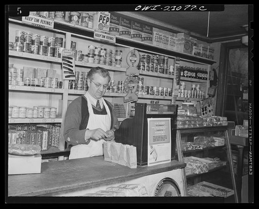 Untitled photo, possibly related to: Washington, D.C. This grocer used paper bags for each denomination for his stamps, which must be surrendered by customers under the point rationing system
