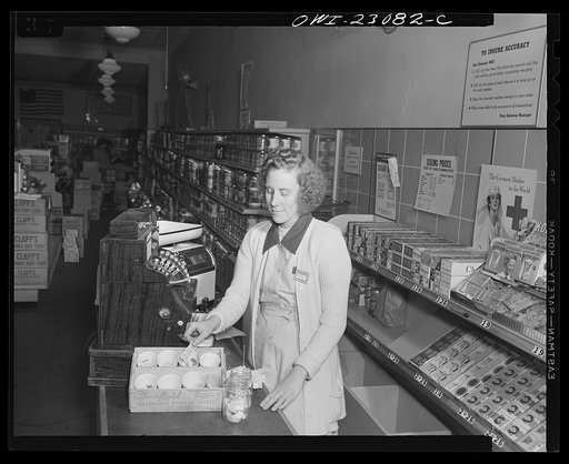 Untitled photo, possibly related to: Washington, D.C. Blue and red point stamps are kept in cheese boxes containing paper cups. Mason jars are used for sugar and coffee stamps, which must be surrendered by customers under the point rationing system