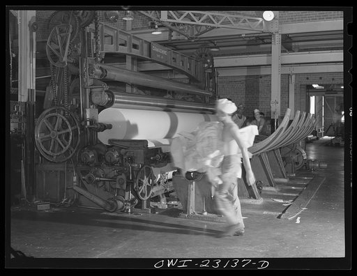 Untitled photo, possibly related to: Lufkin, Texas. Southland paper mill. Moving finished roll of newsprint from the paper machine to the cutting machine
