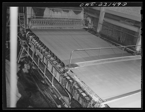 Untitled photo, possibly related to: Lufkin, Texas. Southland paper mill. Wet end of a paper machine. Water is drawn from the stock as it flows across a screen and becomes paper