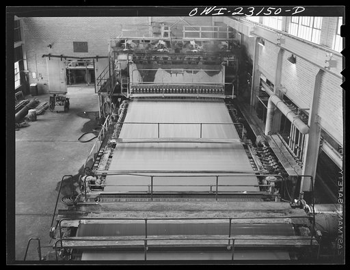 Untitled photo, possibly related to: Lufkin, Texas. Southland paper mill. Stock flowing along the screen of a paper machine becomes paper as water is drawn off by suction