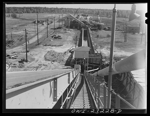 Lufkin, Texas. Southland paper mill. Wood yard showing conveyor belt leading to grinding machines