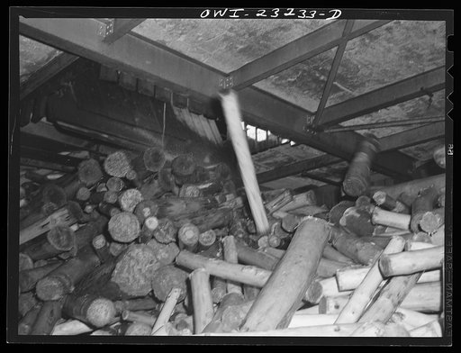 Untitled photo, possibly related to: Lufkin, Texas. Southland paper mill. The lumber room is filled with enough barked logs from the wood yard during the day so that operations in the grinding room and on the paper machine can go on all night