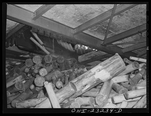 Untitled photo, possibly related to: Lufkin, Texas. Southland paper mill. The lumber room is filled with enough barked logs from the wood yard during the day so that operations in the grinding room and on the paper machine can go on all night
