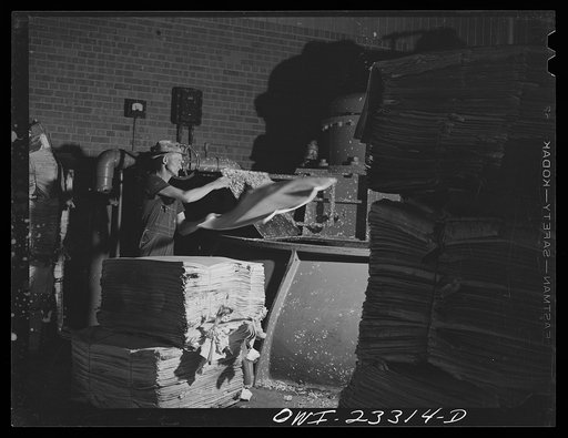 Lufkin, Texas. Southland paper mill. Putting sheets of Kraft paper into a vortex beater which reduces them to pulp, twenty percent of which is added to the ground wood of slash pine to make newsprint