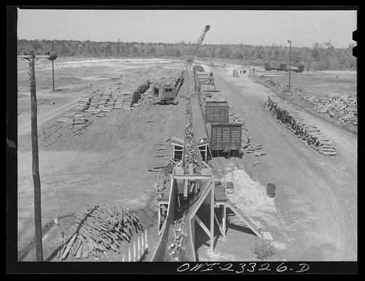 Lufkin, Texas. Southland paper mill. Logs being conveyed from the woodyard to the barking machine