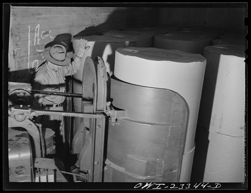 Untitled photo, possibly related to: Lufkin, Texas. Southland paper mill. Loading roll of newsprint into a freight car
