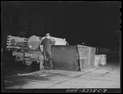 Dallas, Texas. Truck unloading rolls of Southland newsprint onto an elevator to the basement of the Dallas Morning News
