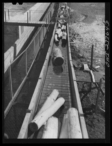 Untitled photo, possibly related to: Lufkin, Texas. Southland paper mill. Pulp wood being conveyed from the barking machine to grinders
