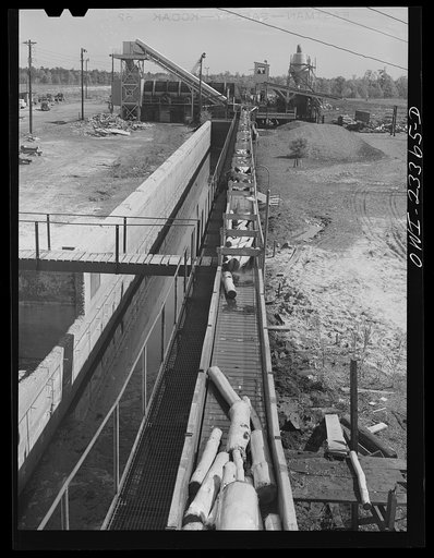 Lufkin, Texas. Southland paper mill. Pulp wood being conveyed from the barking machine to grinders