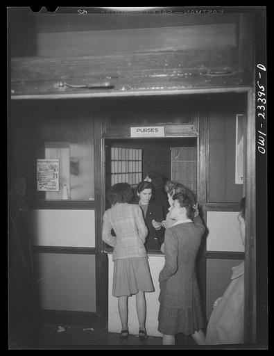 Untitled photo, possibly related to: Buffalo, New York. Checking purses at the swingshift dance which is held weekly from midnight to four a.m. at the Main-Utica ballroom