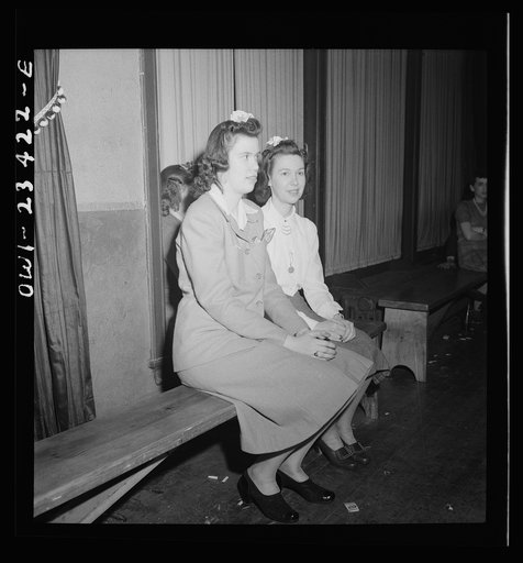 Buffalo, New York. Swingshift workers sitting on the sidelines at the weekly shift dance held from midnight to four a.m. at the Main-Utica ballroom