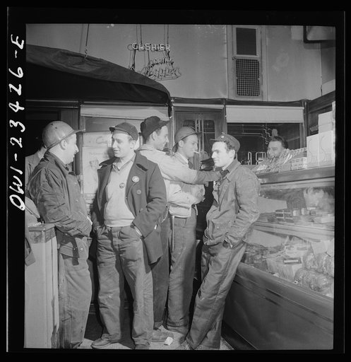 Baltimore, Maryland. Third shift defense workers waiting in a combination delicatessen and restaurant to be picked up by their car pools around midnight