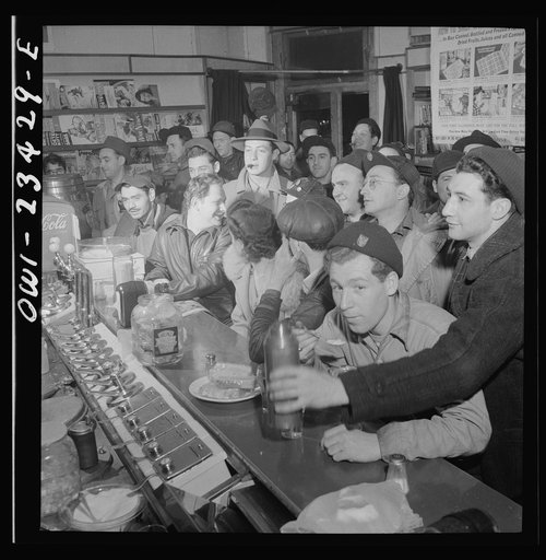 Baltimore, Maryland. Third shift defense workers getting snack at drugstore on corner where their shared car will pick them up around midnight