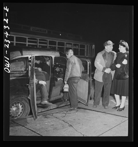 Baltimore, Maryland. Third shift defense workers being picked up by a car pool around midnight