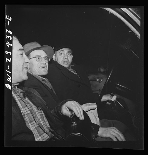 Baltimore, Maryland. Third shift defense workers starting to work in a car pool around midnight