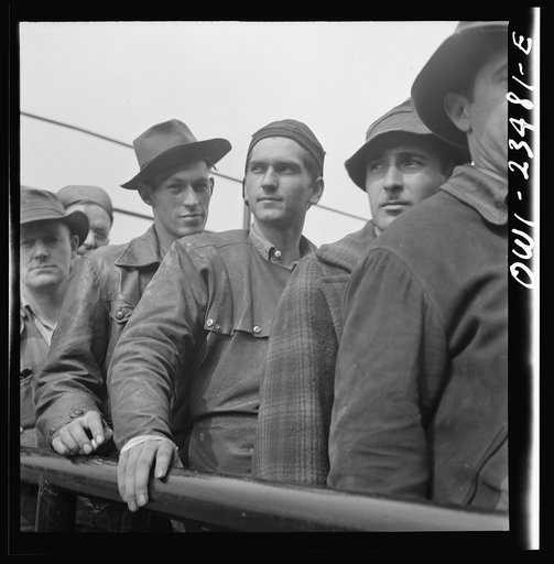 Bethlehem-Fairfield shipyards, Baltimore, Maryland. Lining up before a time clock at the changing of the shifts