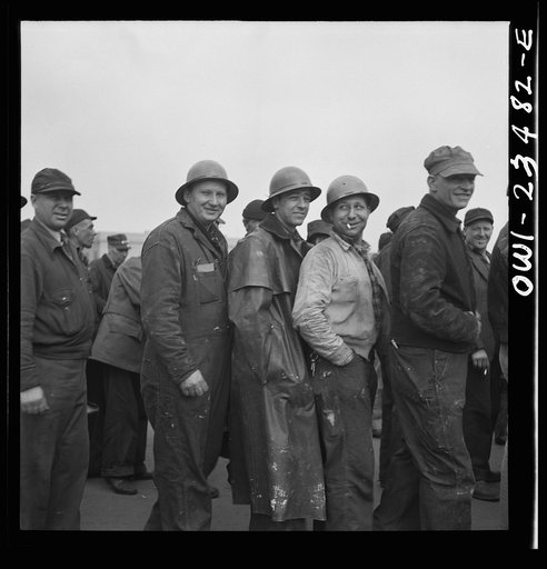 Bethlehem-Fairfield shipyards, Baltimore, Maryland. Lining up before a time clock at the changing of the shifts