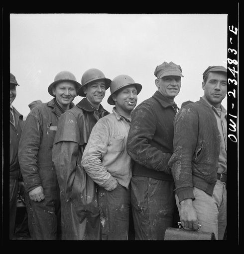 Bethlehem-Fairfield shipyards, Baltimore, Maryland. Lining up before a time clock at the changing of the shifts