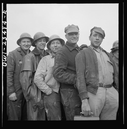 Bethlehem-Fairfield shipyards, Baltimore, Maryland. Lining up before a time clock at the changing of the shifts