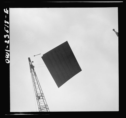 Bethlehem-Fairfield shipyards, Baltimore, Maryland. Deck section being lowered onto a ship