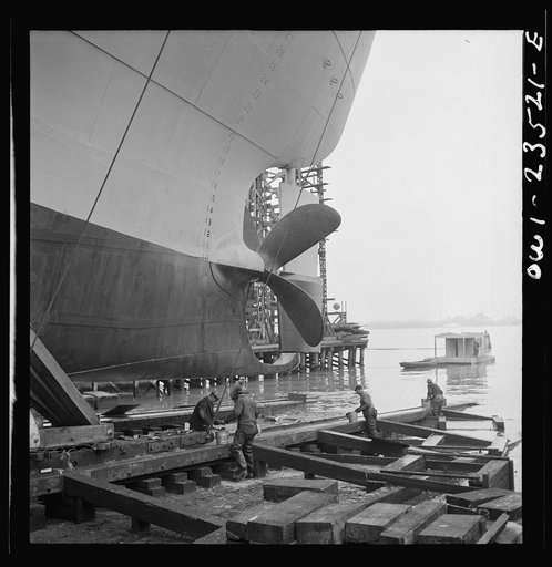 Bethlehem-Fairfield shipyards, Baltimore, Maryland. Greasing outboard end of the ways just before a launching